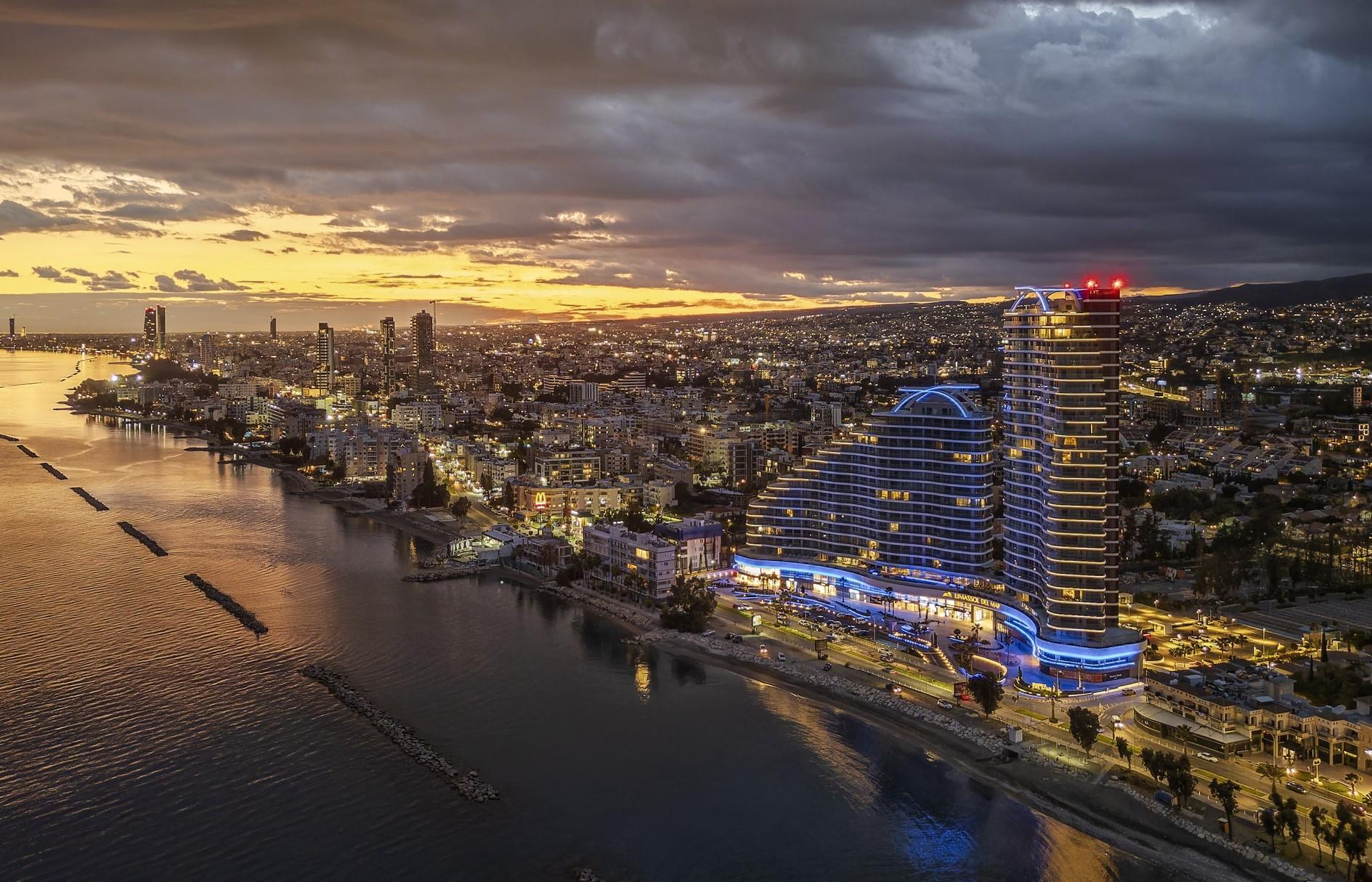 Panoramic view of the Limassol coastline and illuminated towers at sunset